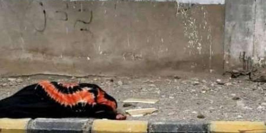 اخبار اليمن | تجسيدا لمعاناة اليمنيين.. امرأة مسنة تنام في الشارع أمام لوحة جدارية للمليشيا الحوثية